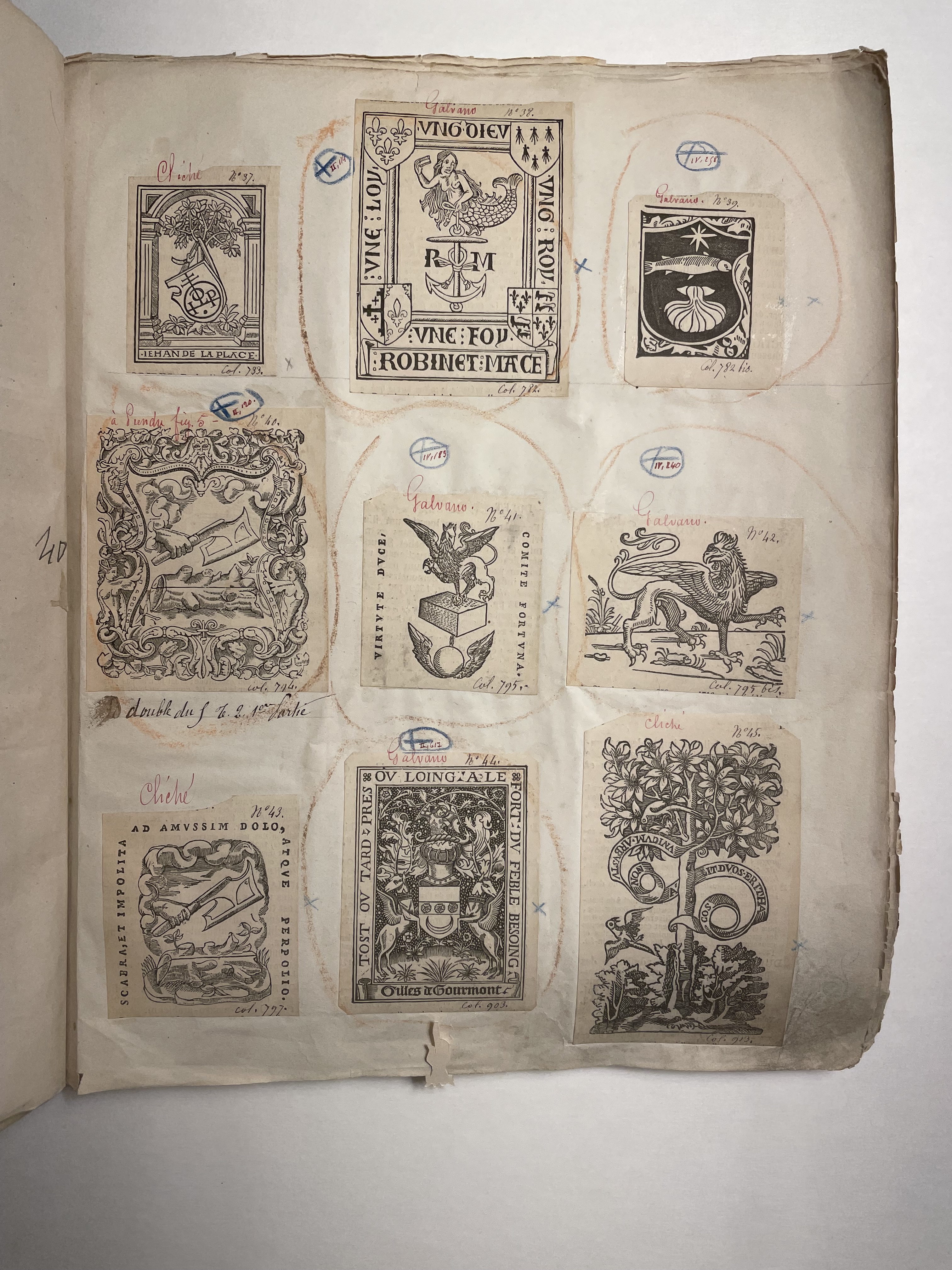 Page of facsimile printer's devices pasted into an album with manuscript marks and notes